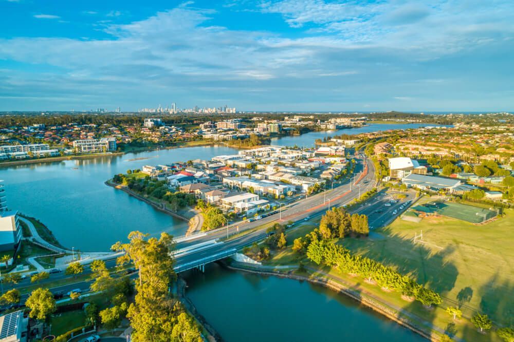 Aerial View Of A City With A Bridge Over A River — CJR Group Concrete Construction In Gold Coast, QLD