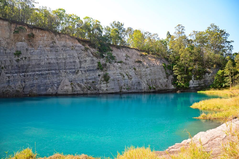 Large Body Of Water Surrounded By Trees And Rocks — CJR Group Concrete Construction In Lismore, NSW