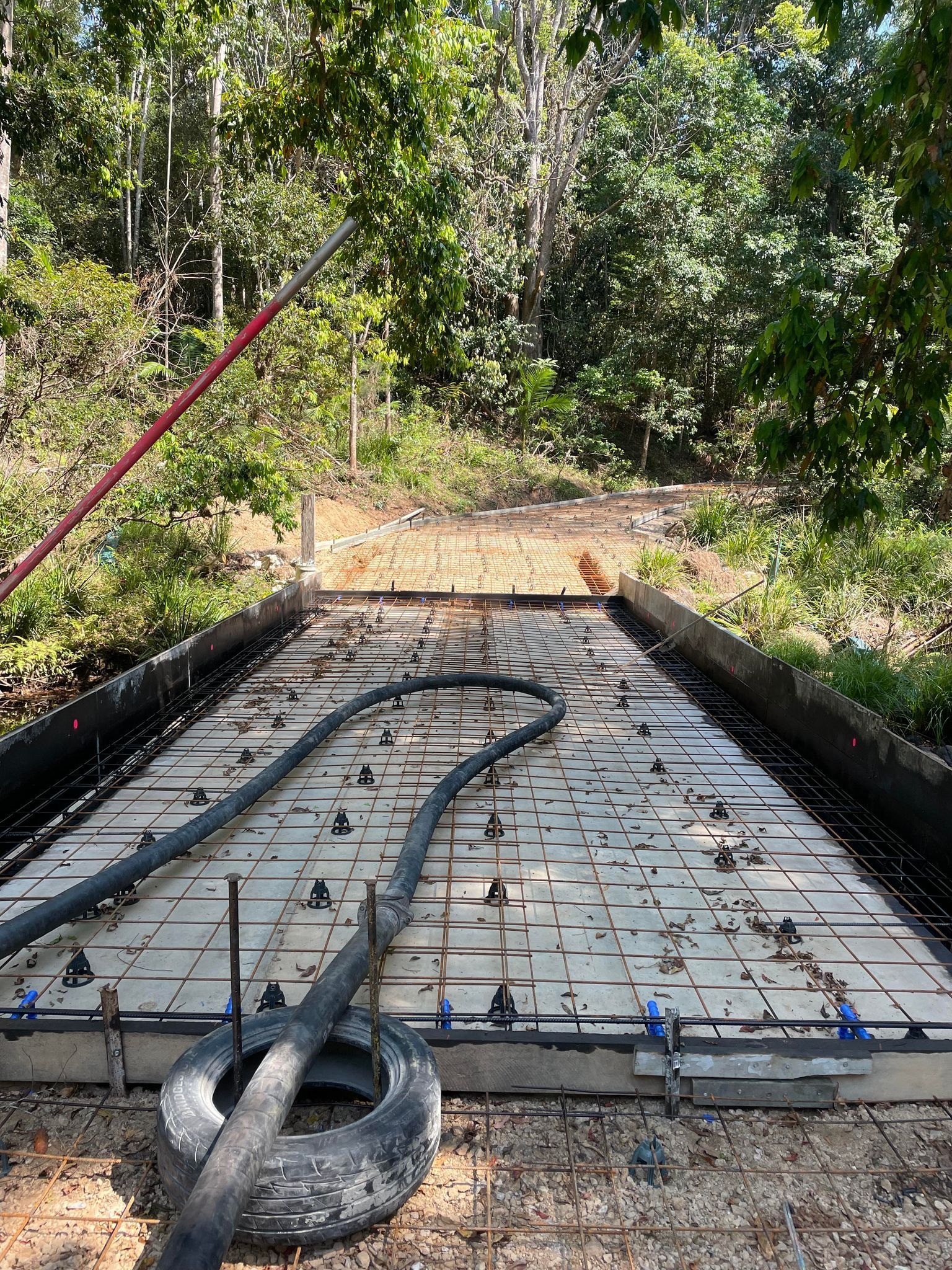 A Hose is Laying on Top of a Concrete Slab — Providing Steel & Concrete Construction In Eviron, NSW