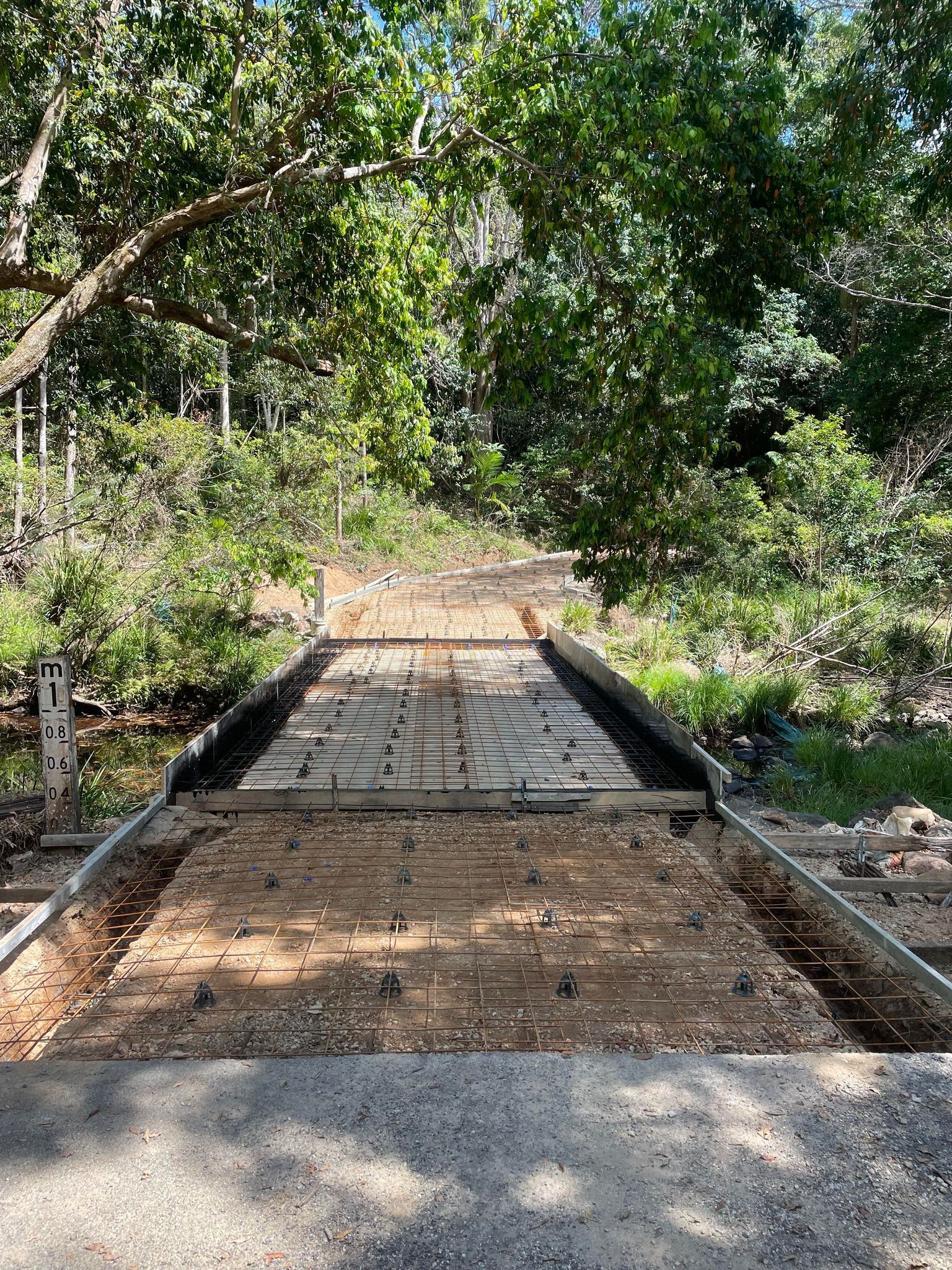 A Concrete Bridge is Being Built in the Middle of a Forest — Providing Steel & Concrete Construction In Eviron, NSW