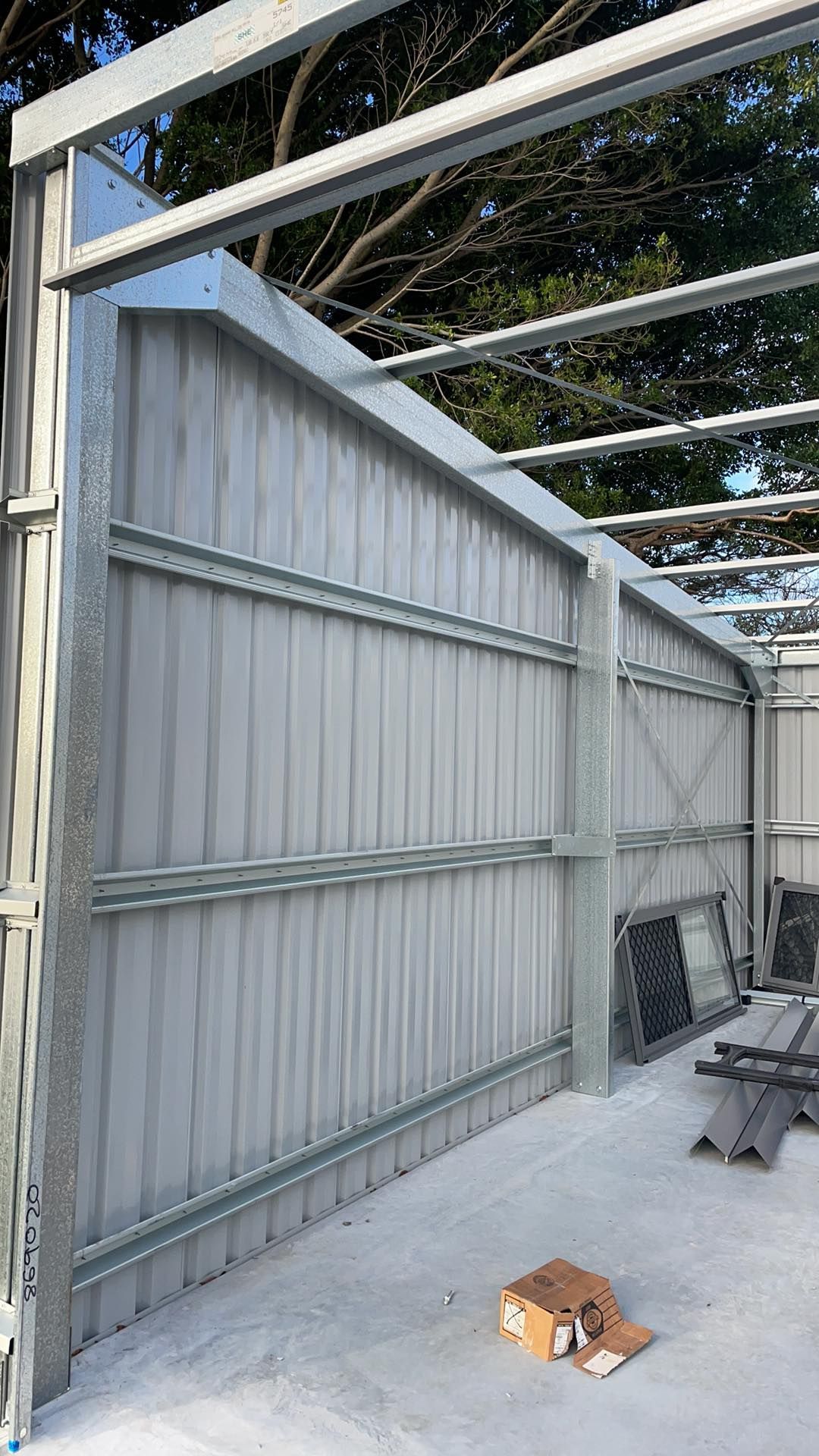 A Metal Structure is Being Built on a Concrete Floor — Providing Steel & Concrete Construction In Eviron, NSW