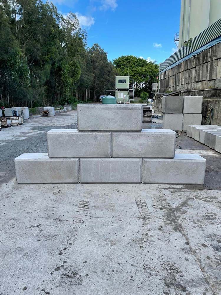 Stack Of Concrete Blocks Sitting On Top Of Each Other On A Concrete Surface — Providing Steel & Concrete Construction In Tweed Heads, NSW