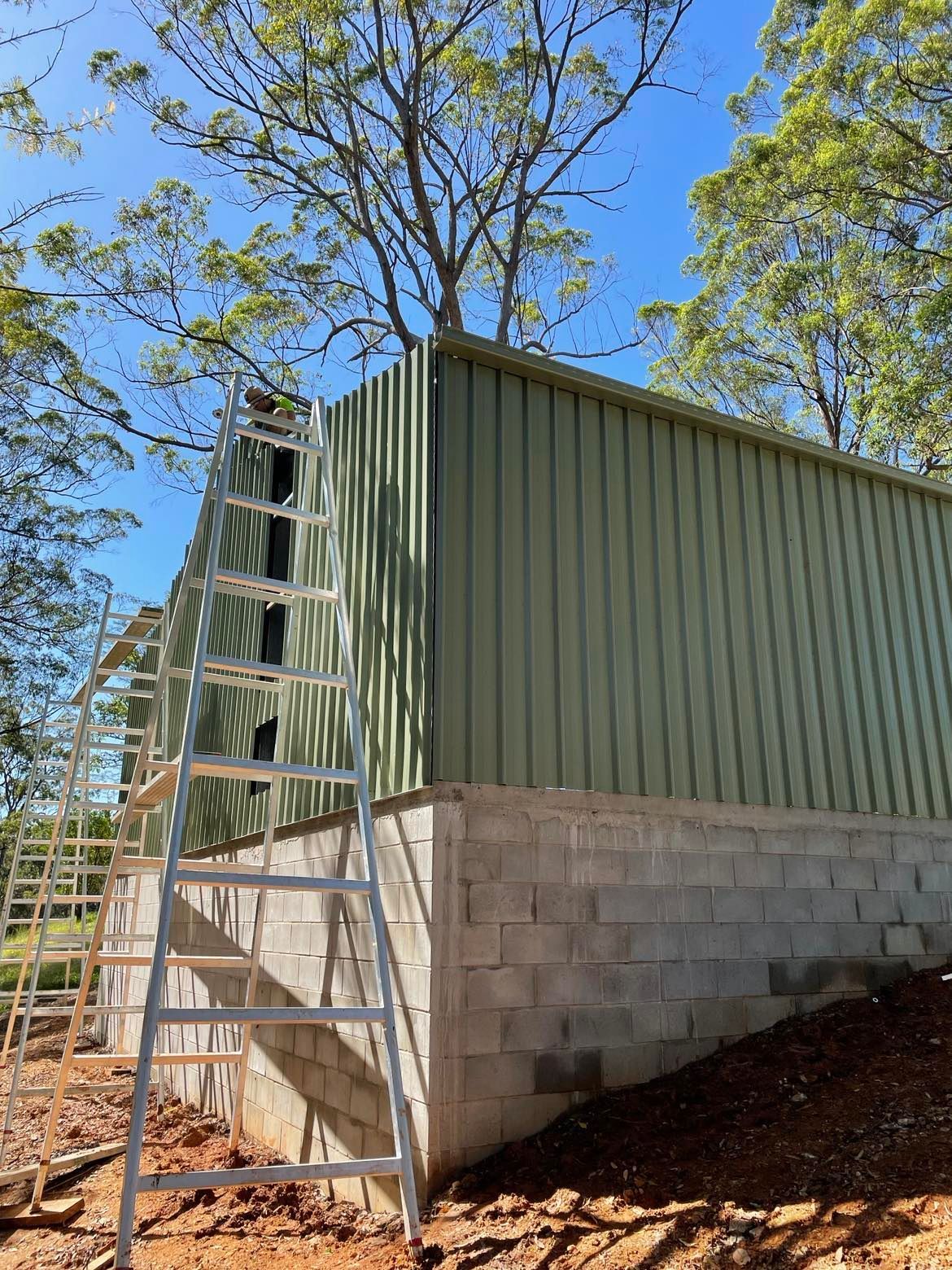 Ladder Sitting On The Side Of A Building — Providing Steel & Concrete Construction In Eviron, NSW