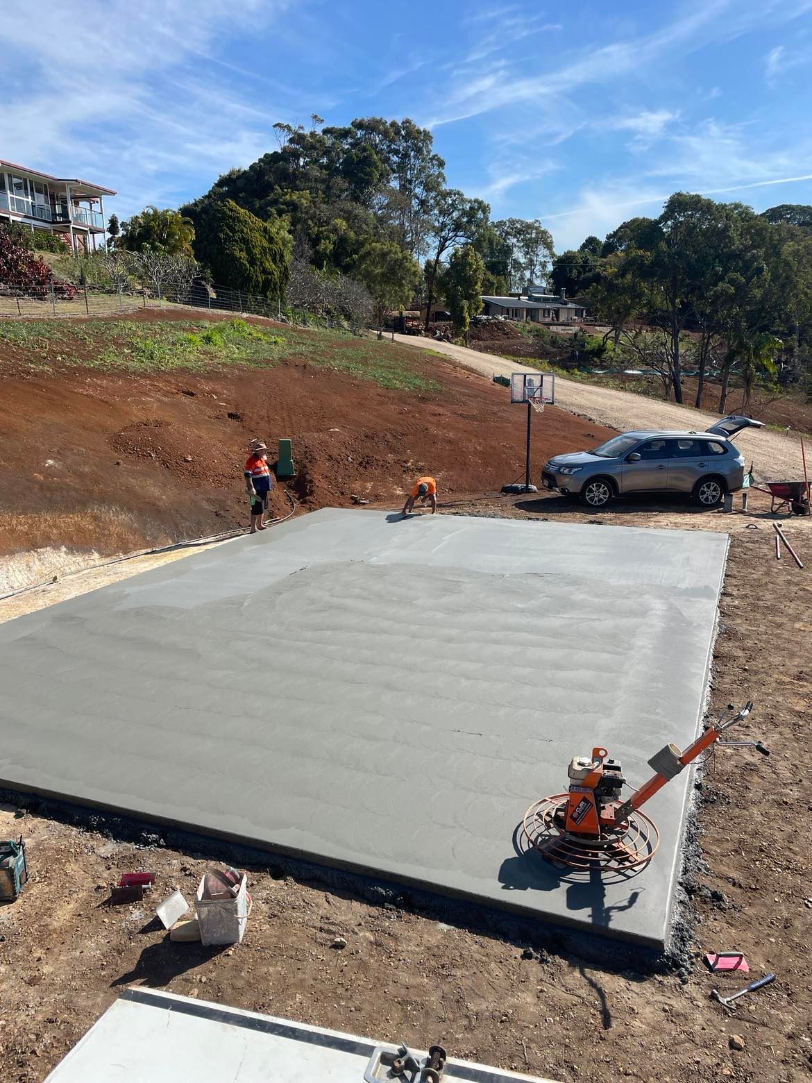 A Large Concrete Slab is Being Built on Top of a Dirt Hill — Providing Steel & Concrete Construction In Eviron, NSW