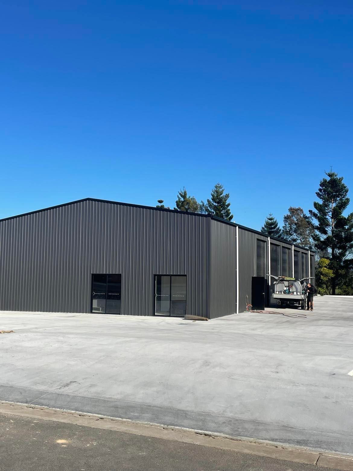 Large Building With A Truck Parked In Front Of It — Providing Steel & Concrete Construction In Tweed Heads, NSW