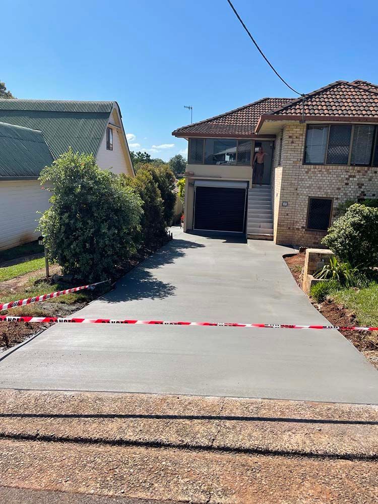 Concrete Driveway Is Being Built In Front Of A House — Providing Steel & Concrete Construction In Tweed Heads, NSW