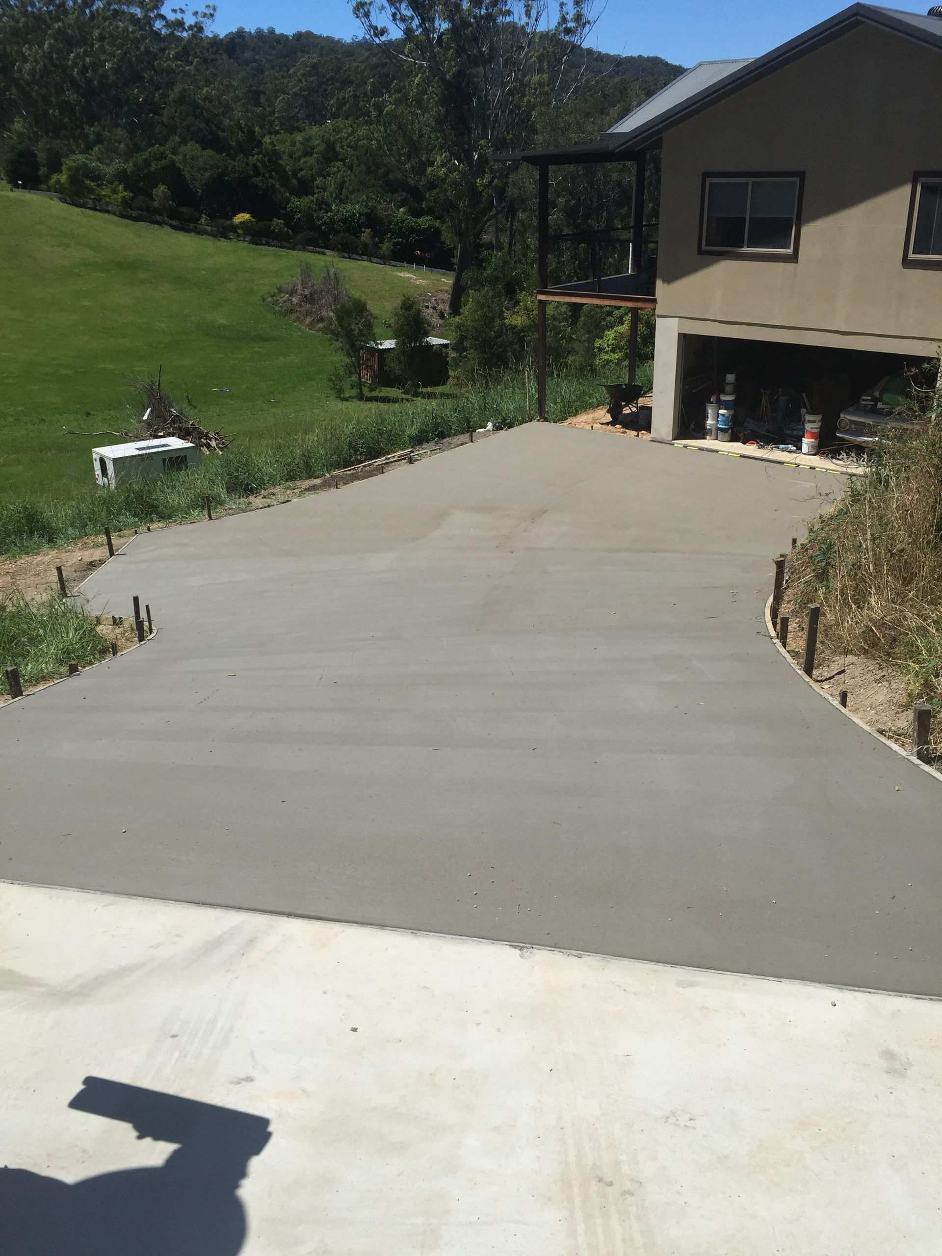 A Concrete Driveway is Being Built in Front of a House — Providing Steel & Concrete Construction In Eviron, NSW