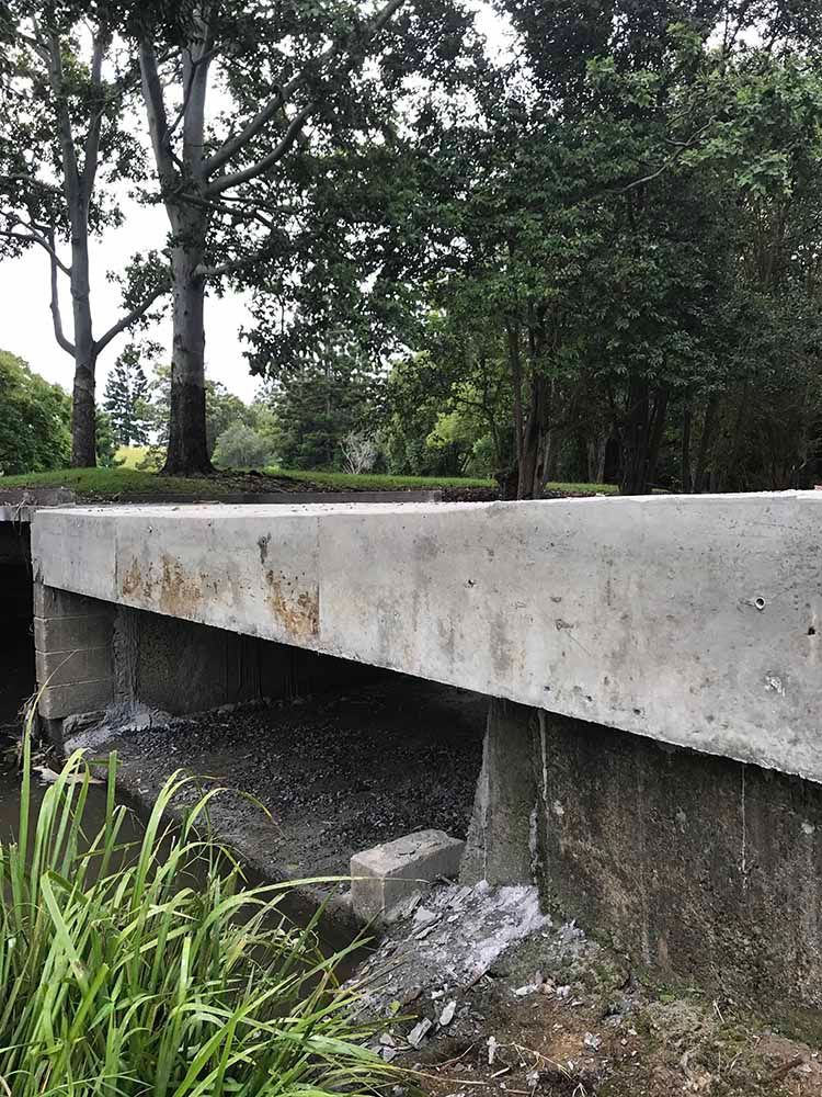 Concrete Bridge Over a River with Trees in the Background — Providing Steel & Concrete Construction in Byron Bay, NSW