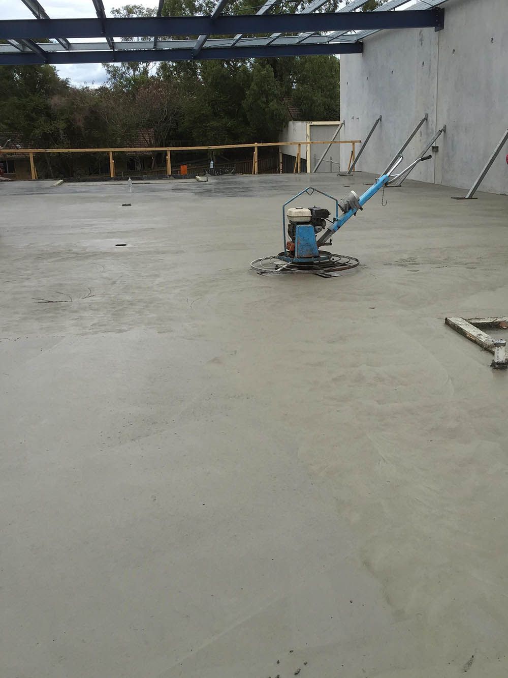 Machine Is Sitting On Top Of A Concrete Floor — Providing Steel & Concrete Construction In Tweed Heads, NSW