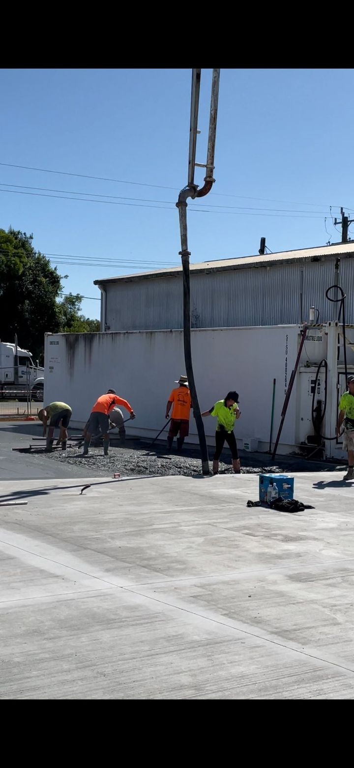 A Group of Construction Workers are Working on a Concrete Floor — Providing Steel & Concrete Construction In Eviron, NSW
