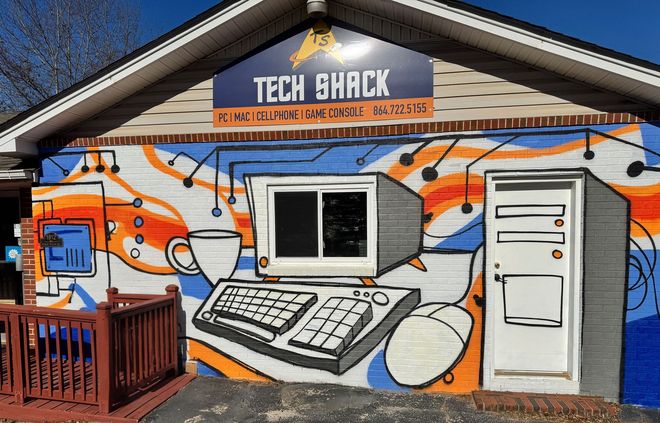 Tech Shack mural on building exterior with giant computer graphics and orange-blue graffiti-style design