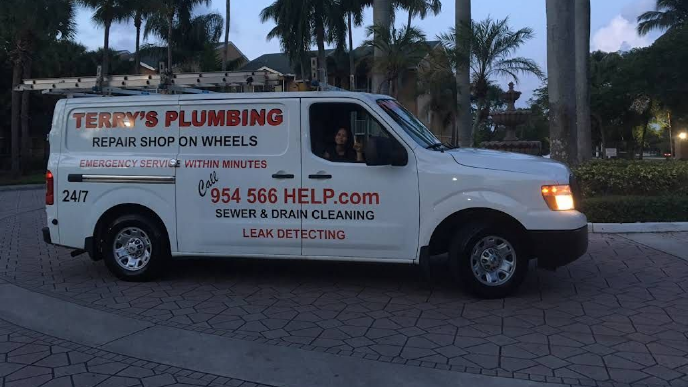 A white Terry's Plumbing service van parked on a paved driveway at dusk, with text advertising sewer and drain services. A white Terry's Plumbing service van parked on a paved driveway at dusk, with text advertising sewer and drain services.