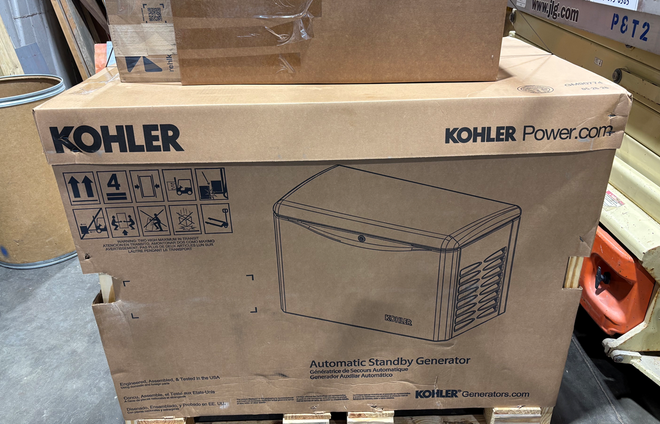 Kohler Power Systems generator box on a warehouse pallet, shown in cardboard packaging.