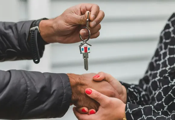 Couple getting house keys from sell of home