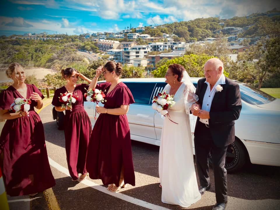 A Bride and Groom Are Walking Towards a Limousine — Noosa Premier Stretch Holden Transfers In Sunrise Beach, QLD