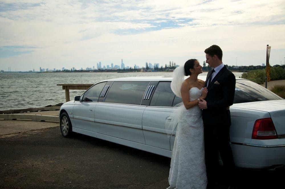 A Man In A Suit Is Opening The Door Of A Car — Noosa Premier Stretch Holden Transfers In Sunrise Beach, QLD