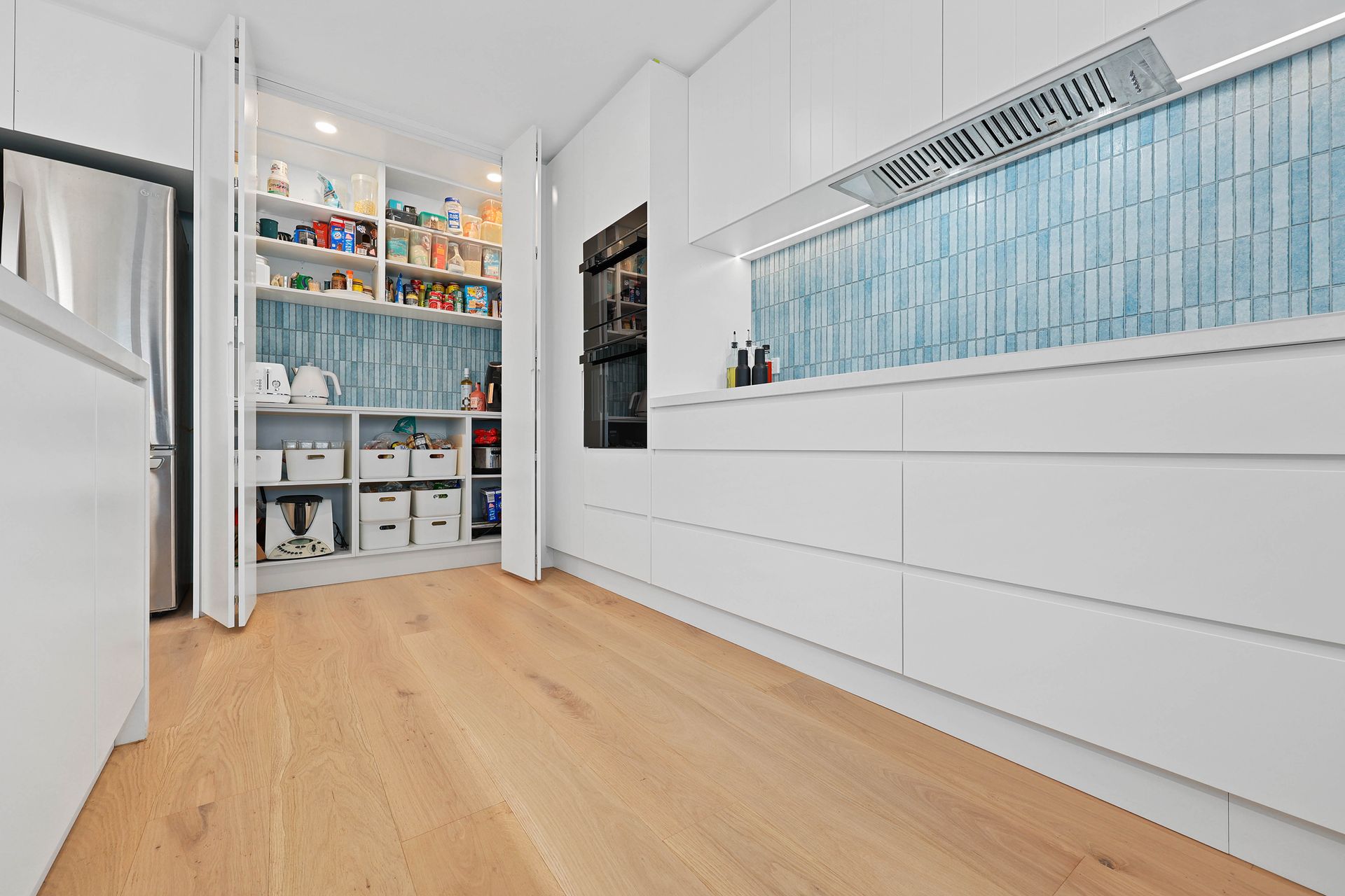 A Kitchen with White Cabinets and A Toaster Oven — Above & Beyond Interiors in Southern Highlands, NSW