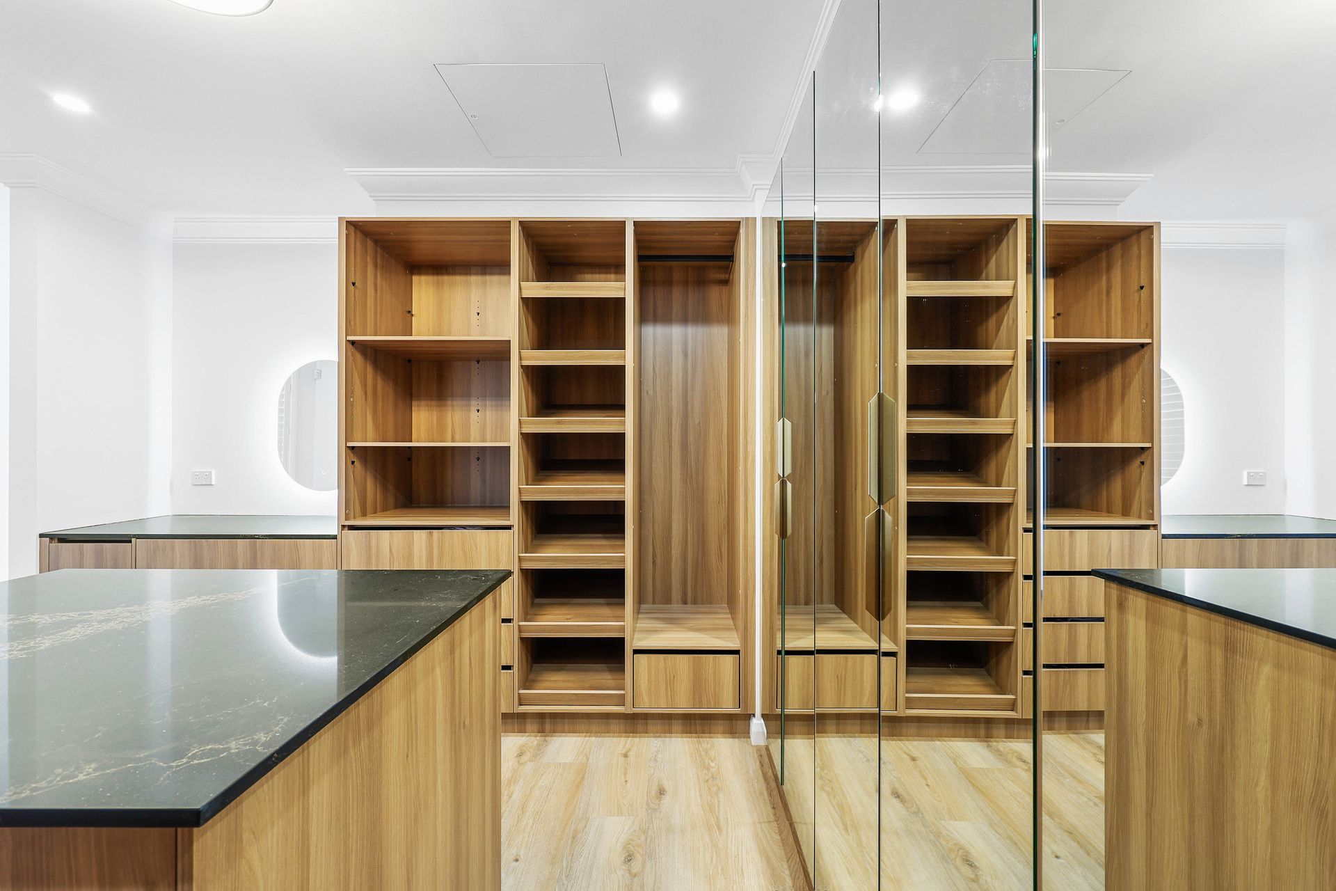 A Walk in Closet with Lots of Wooden Shelves and Drawers — Above & Beyond Interiors in Smeaton Grange, NSW