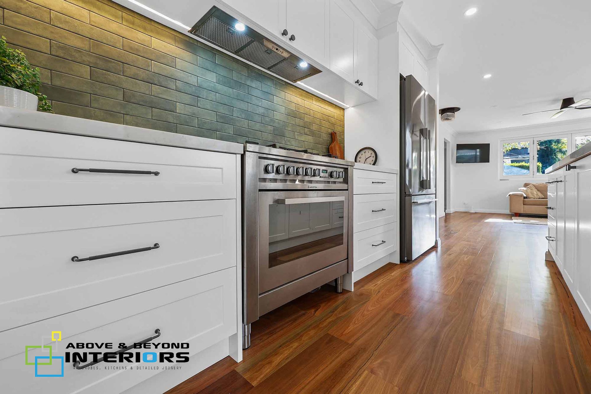 Modern White Kitchen With Stainless Steel Oven — Above & Beyond Interiors in Camden, NSW