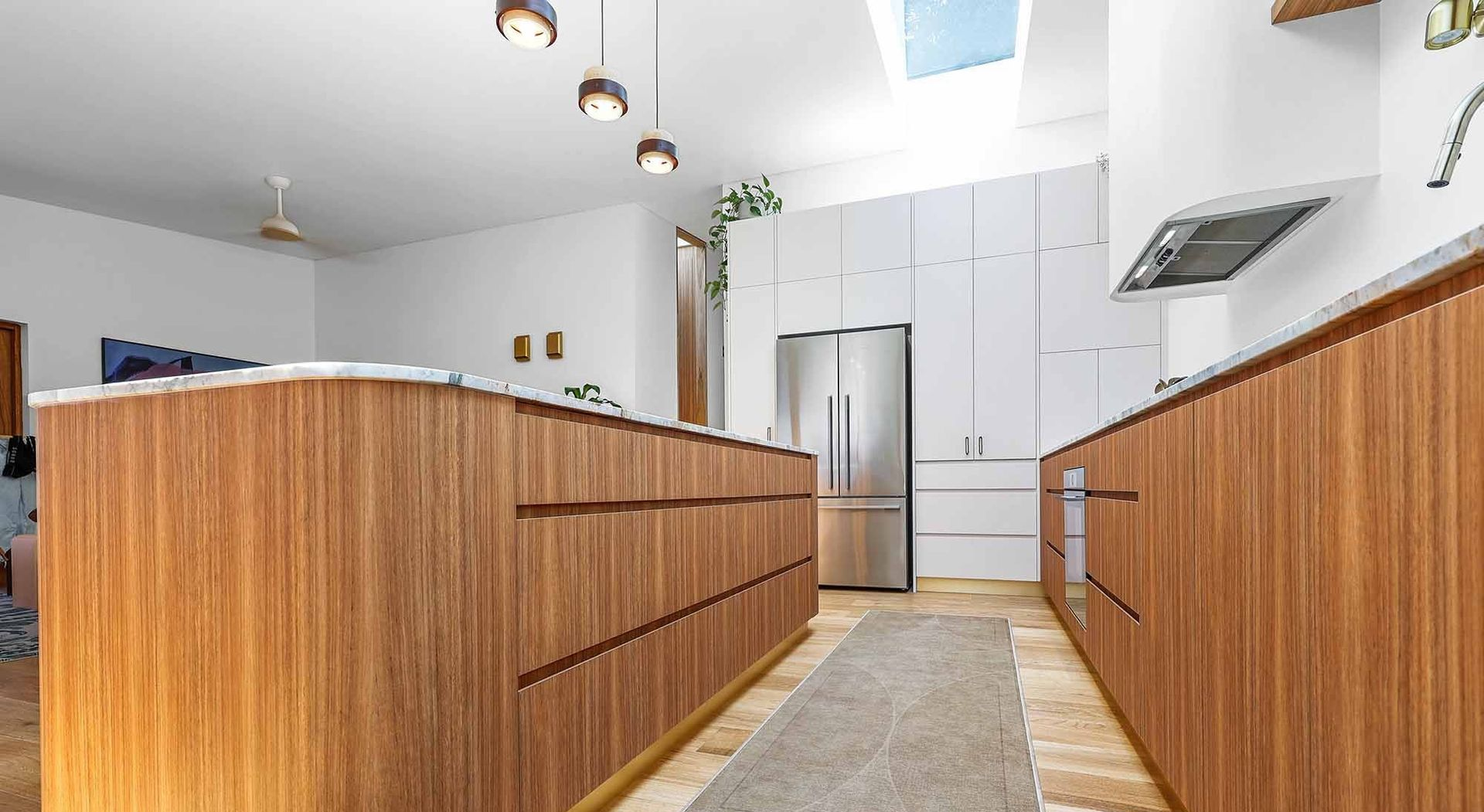Kitchen With Wooden Cabinets With White Walls