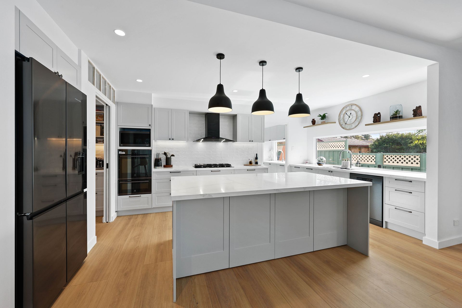 Bright Modern Kitchen with Gray Island — Above & Beyond Interiors in Smeaton Grange, NSW