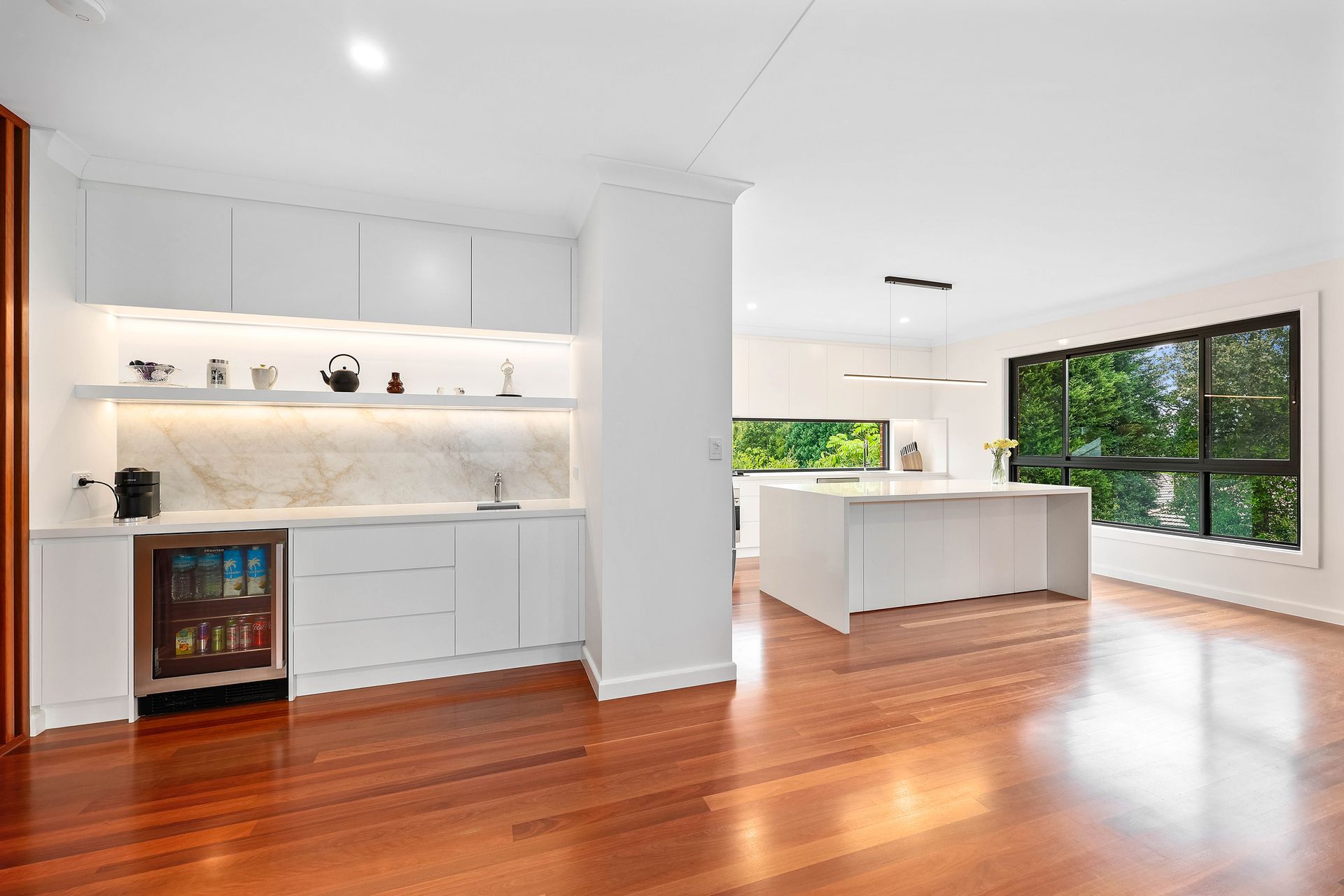 Bright Open Kitchen and Living Area with White Cabinetry — Above & Beyond Interiors in Smeaton Grange, NSW