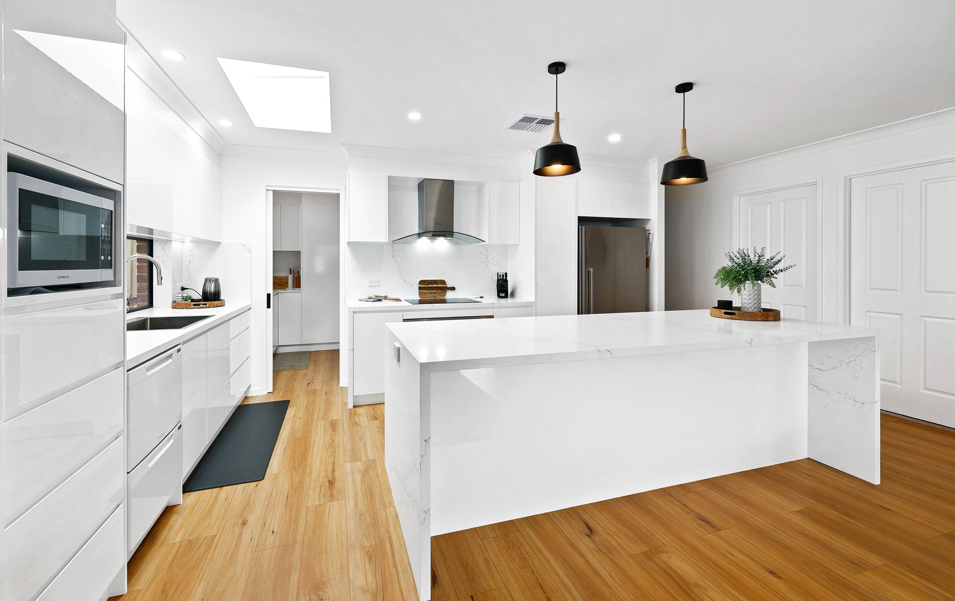 Bright White Modern Kitchen with Island — Above & Beyond Interiors in Smeaton Grange, NSW