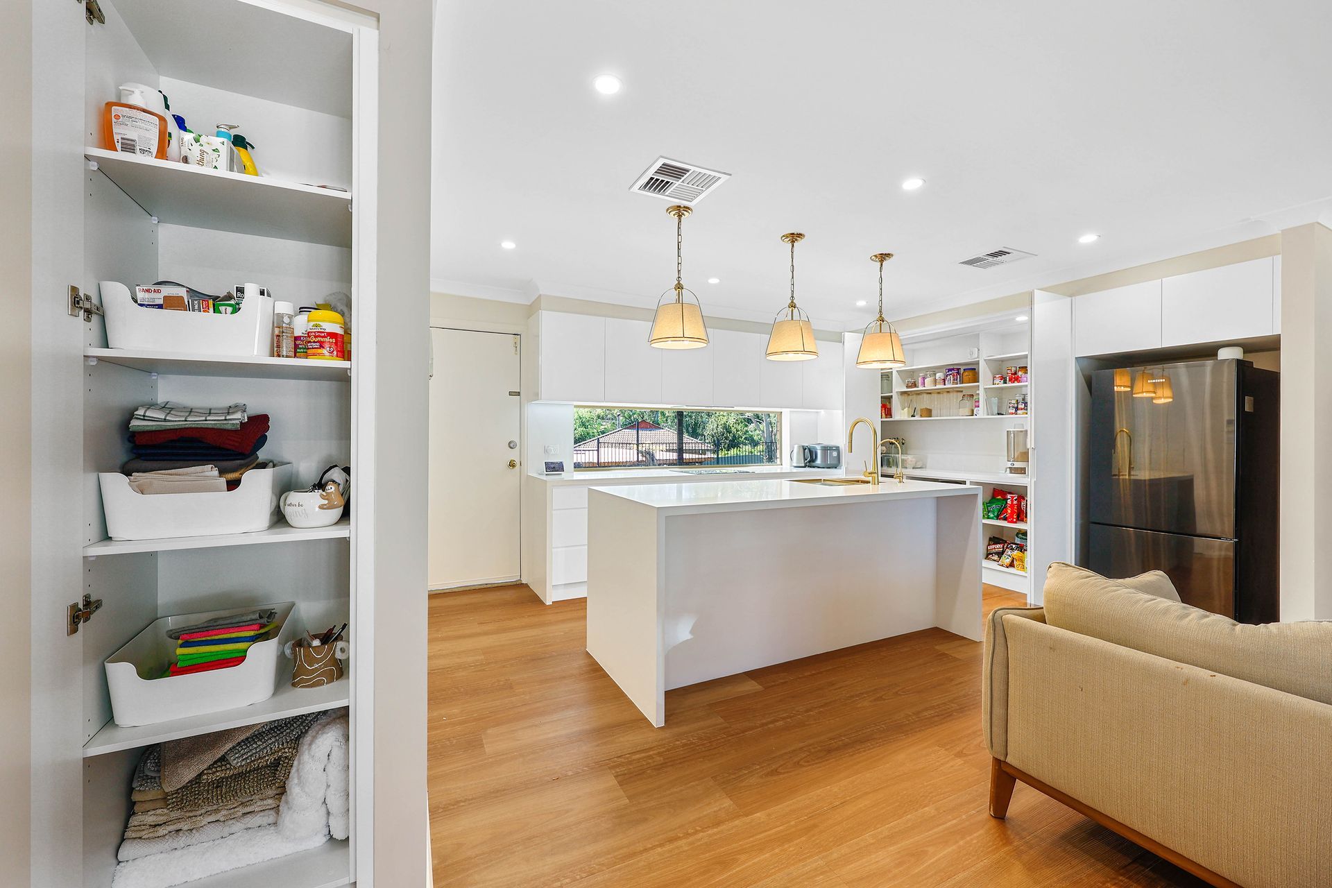 Bright Modern Kitchen and Living Area With White Island — Above & Beyond Interiors in Smeaton Grange, NSW
