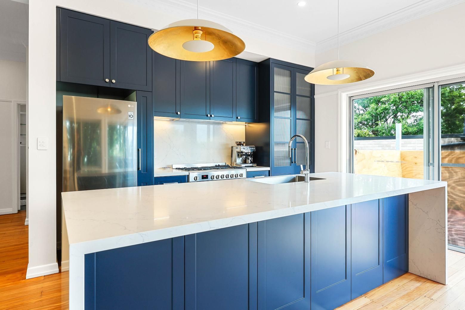 Modern Kitchen With Navy Cabinets, White Island — Above & Beyond Interiors in Smeaton Grange, NSW