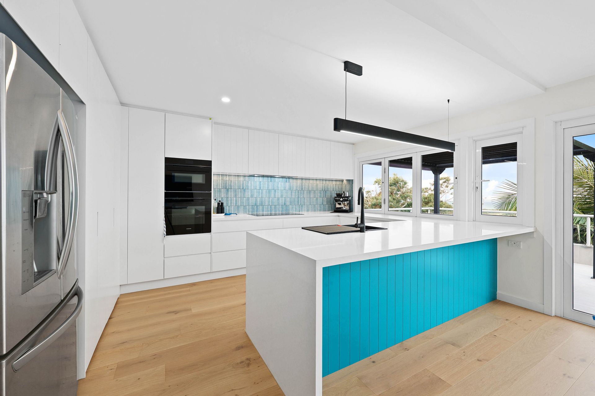 Modern White Kitchen with Turquoise Island — Above & Beyond Interiors in Smeaton Grange, NSW