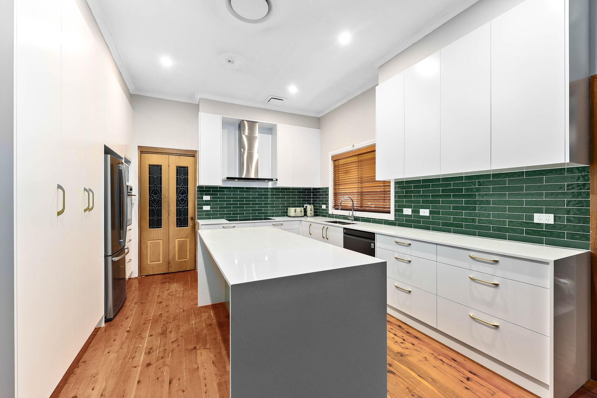 Modern Kitchen with White Cabinets — Above & Beyond Interiors in Smeaton Grange, NSW