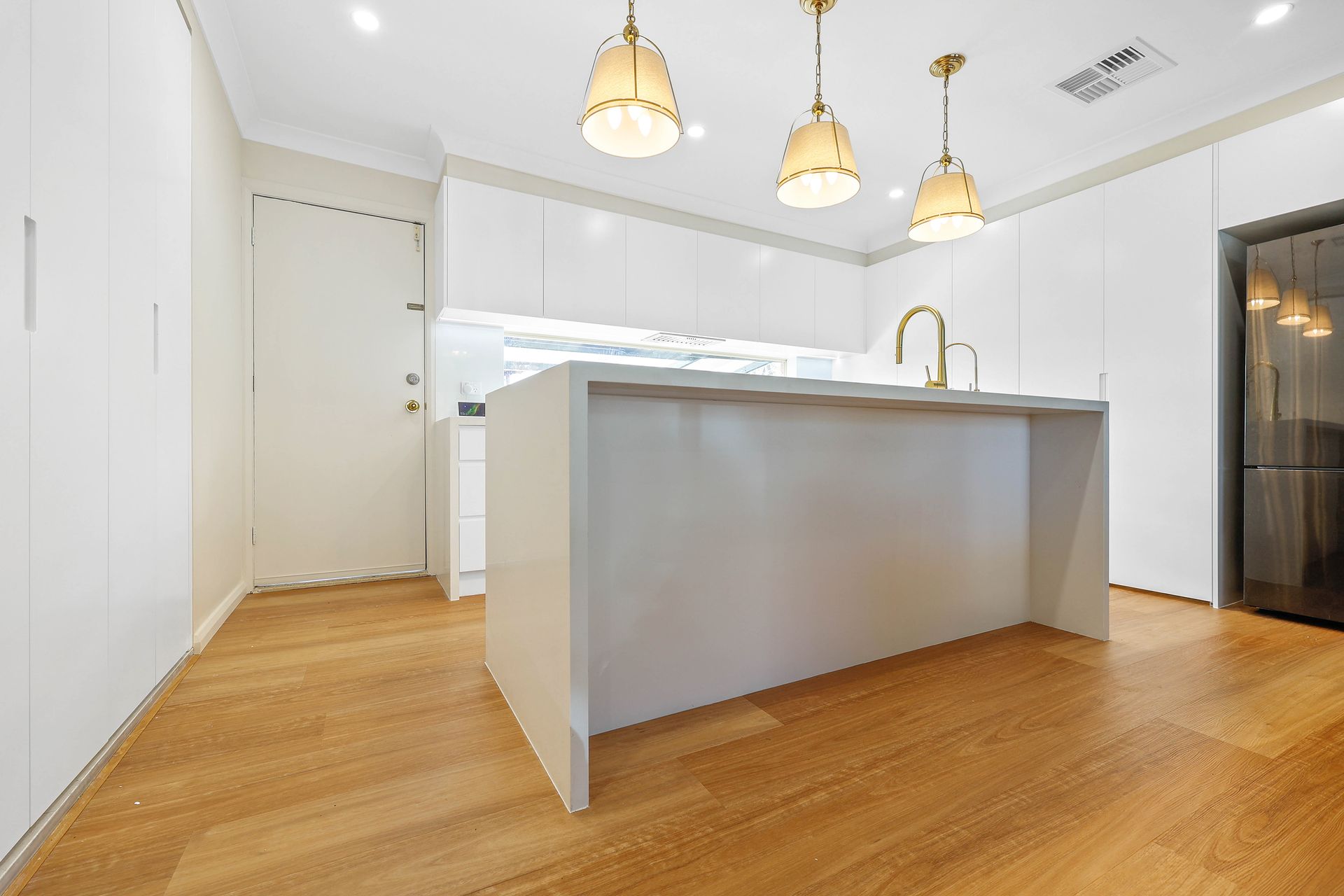 Modern Kitchen With White Cabinets, Wood Floors — Above & Beyond Interiors in Smeaton Grange, NSW