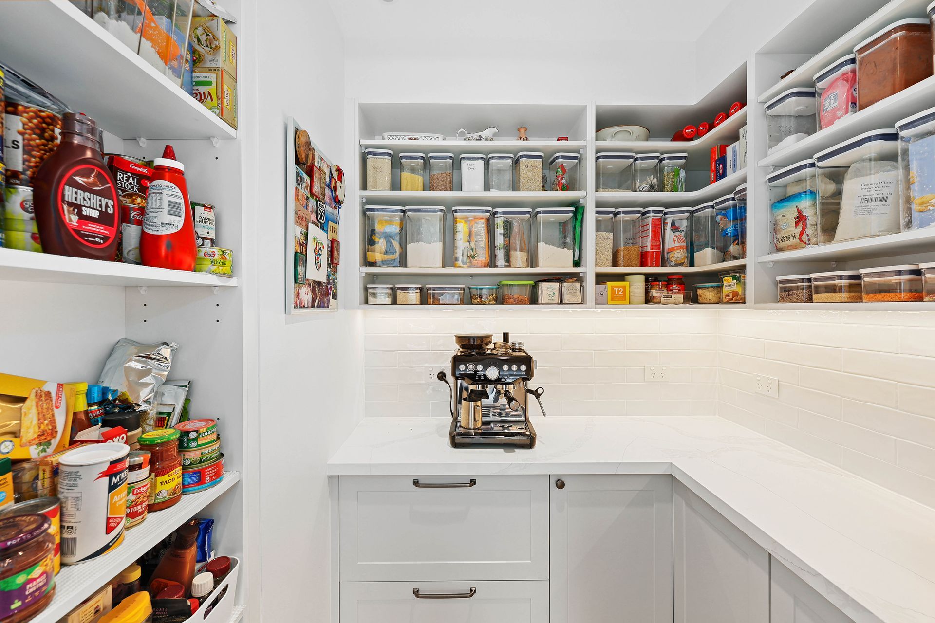 Bright White Walk-In Pantry with Open Shelves Stocked — Above & Beyond Interiors in Smeaton Grange, NSW