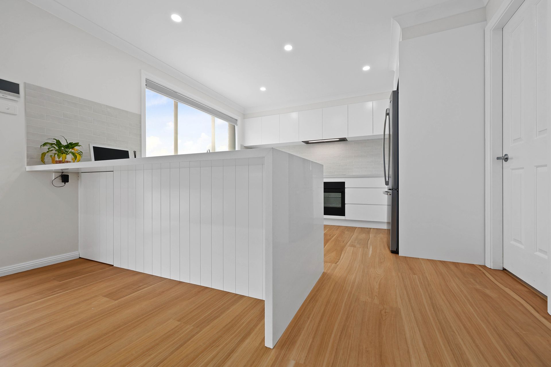 Bright Modern Kitchen with White Cabinets — Above & Beyond Interiors in Smeaton Grange, NSW