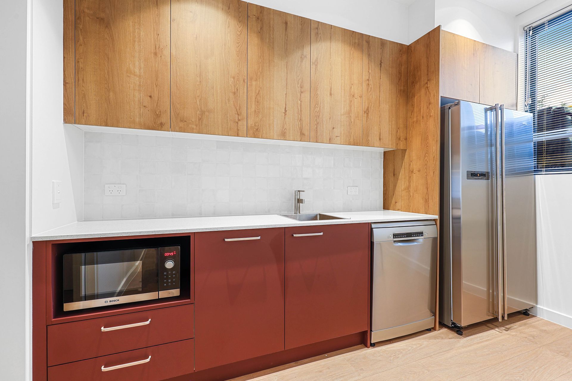 Modern Kitchen With Red Cabinets — Above & Beyond Interiors in Smeaton Grange, NSW