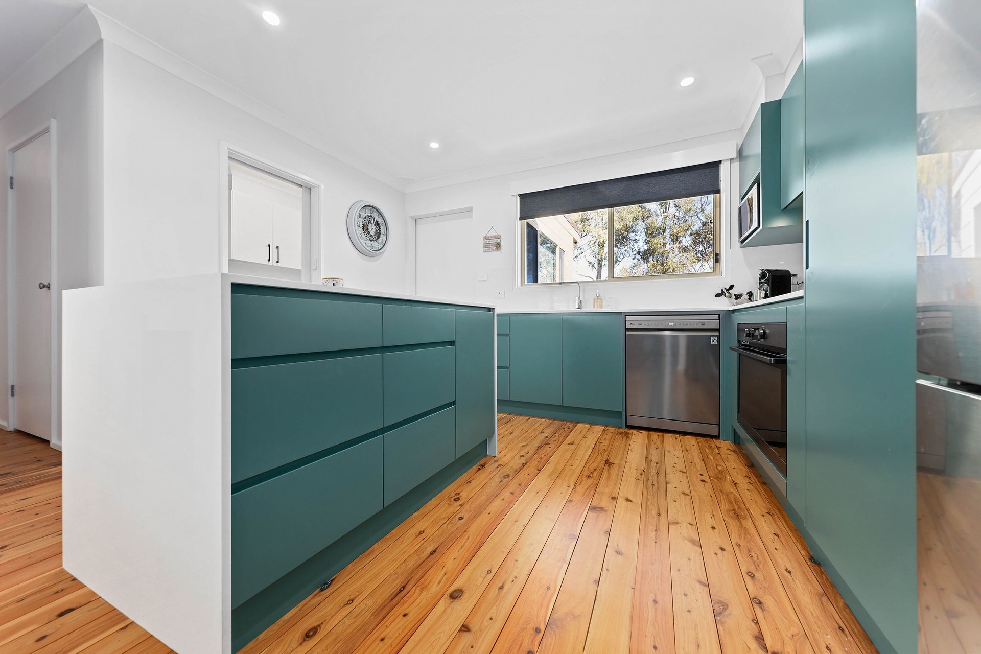 Kitchen With Teal Cabinets, White Island — Above & Beyond Interiors in Smeaton Grange, NSW