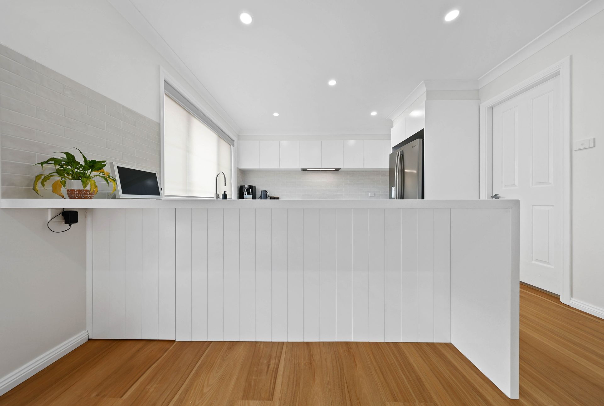 Bright White Modern Kitchen with Island — Above & Beyond Interiors in Smeaton Grange, NSW
