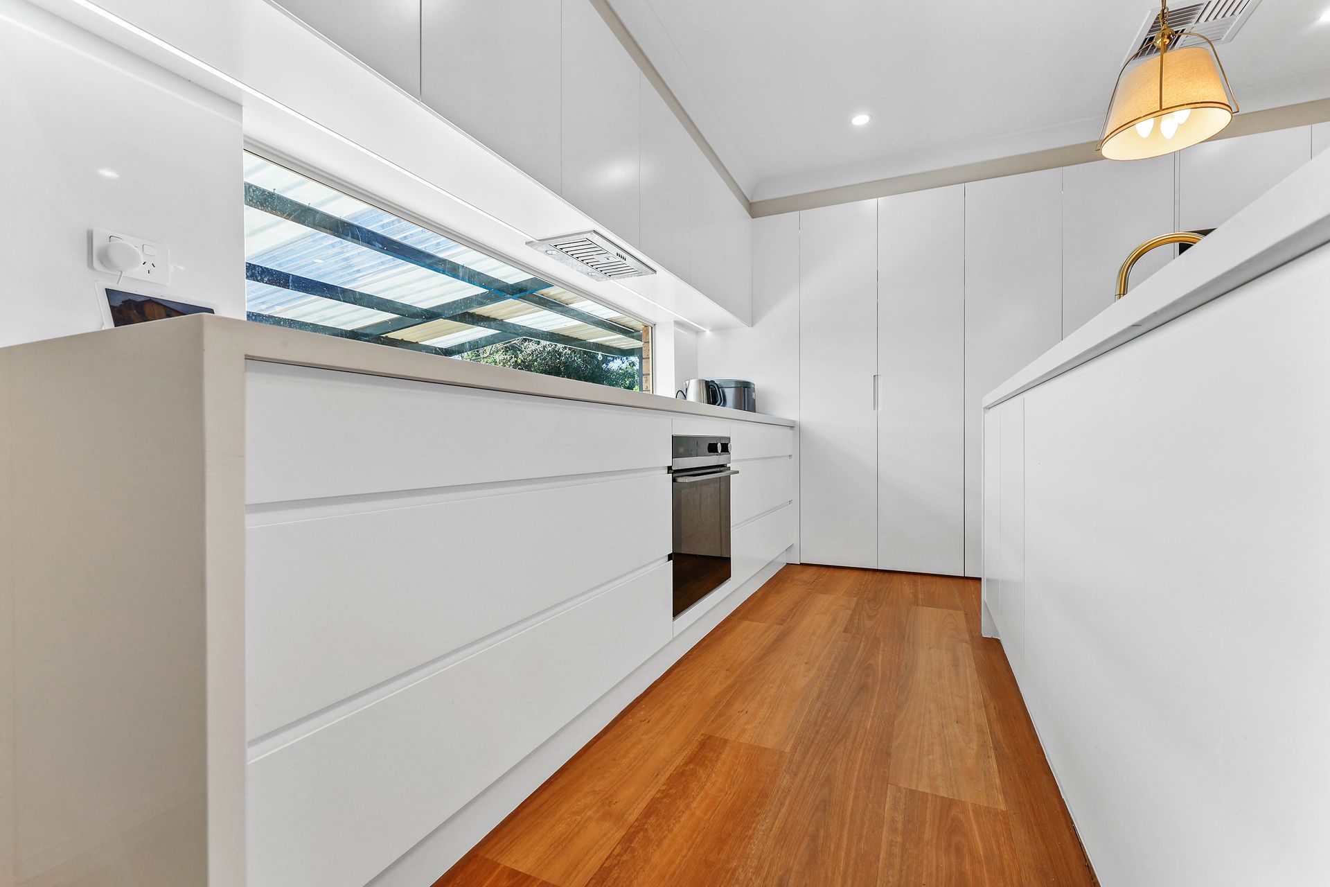 Bright Modern Kitchen With White Cabinets — Above & Beyond Interiors in Smeaton Grange, NSW