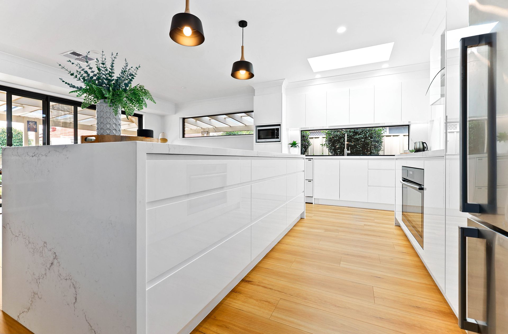 Bright Modern Kitchen with White Cabinets — Above & Beyond Interiors in Smeaton Grange, NSW
