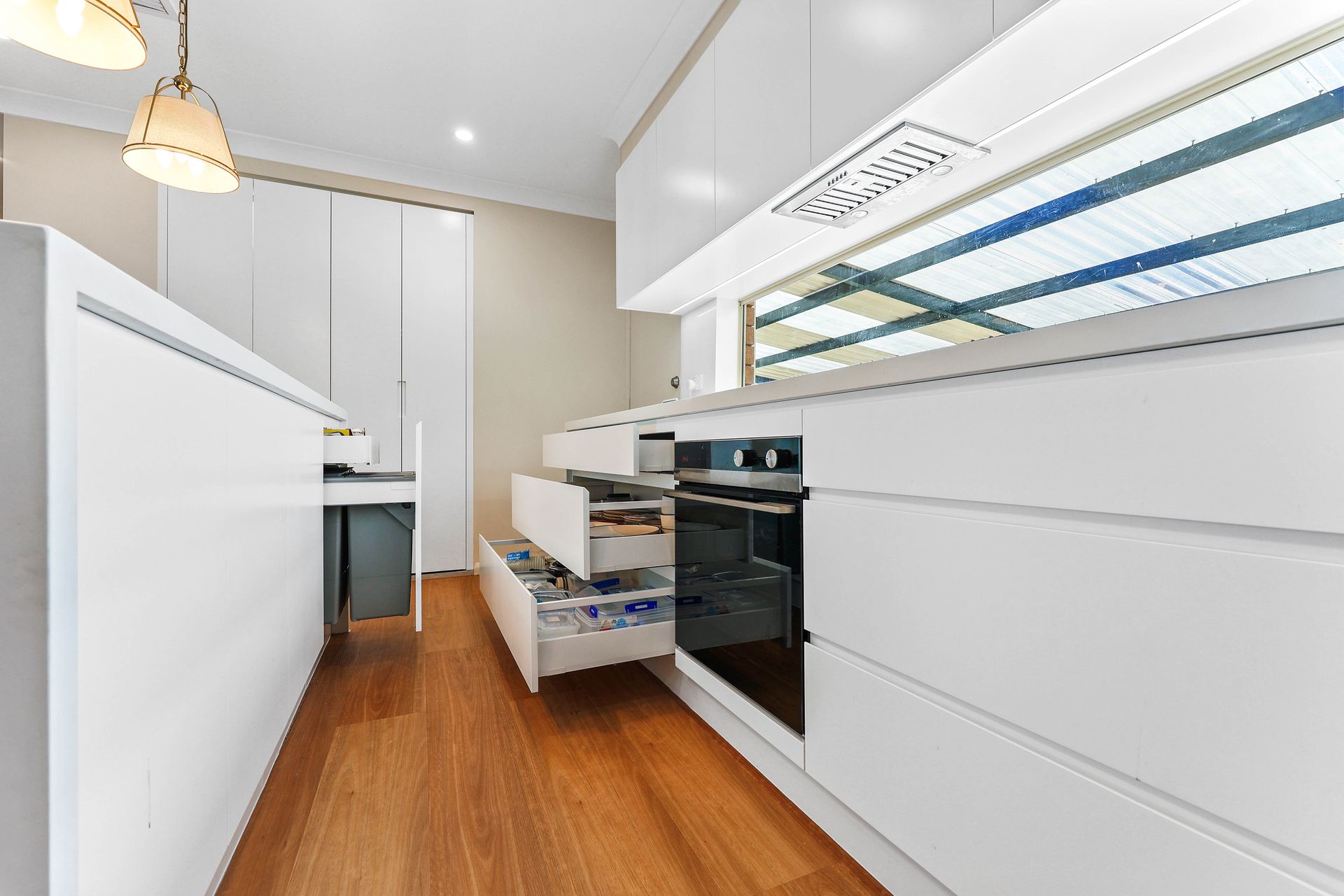 Bright Office Corridor With White Desks — Above & Beyond Interiors in Smeaton Grange, NSW