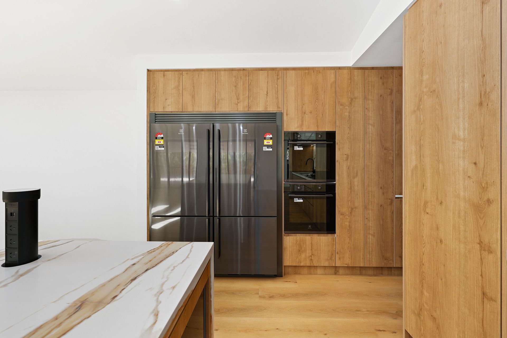 Modern Kitchen with Stainless Steel Refrigerator — Above & Beyond Interiors in Smeaton Grange, NSW