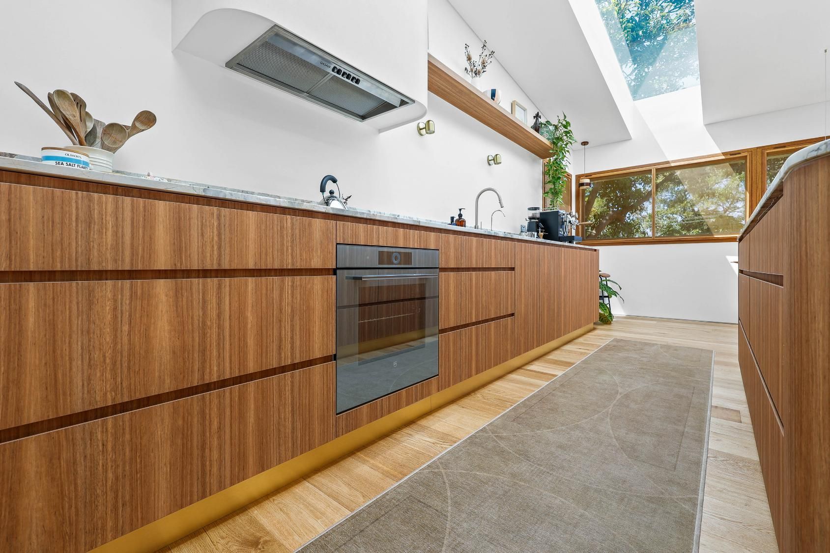 Modern Kitchen With Wood Cabinets, Built-in Oven — Above & Beyond Interiors in Smeaton Grange, NSW