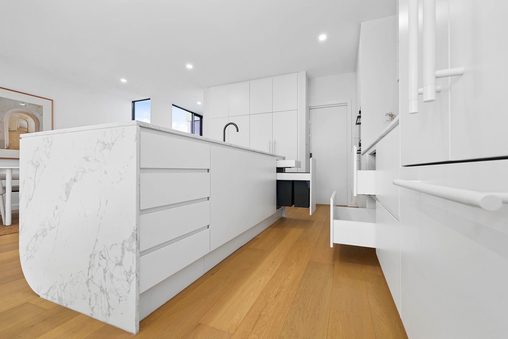 Bright White Modern Kitchen With Marble Island — Above & Beyond Interiors in Smeaton Grange, NSW