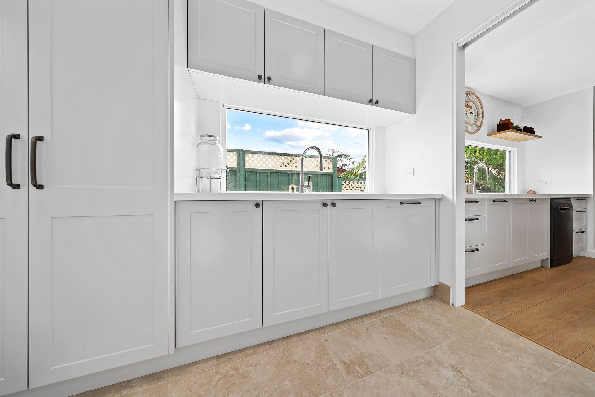 Bright White Kitchen with Gray Cabinets — Above & Beyond Interiors in Smeaton Grange, NSW
