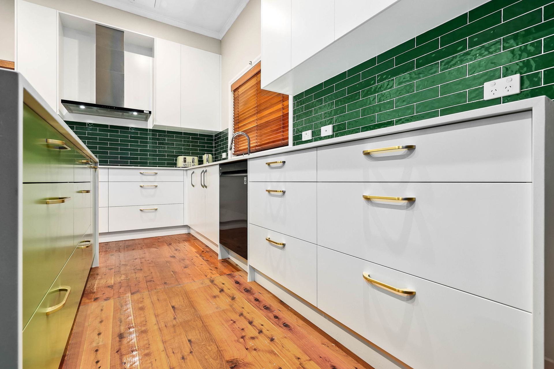 Modern Kitchen with Wood Floor, and Stainless Steel Appliances — Above & Beyond Interiors in Smeaton Grange, NSW