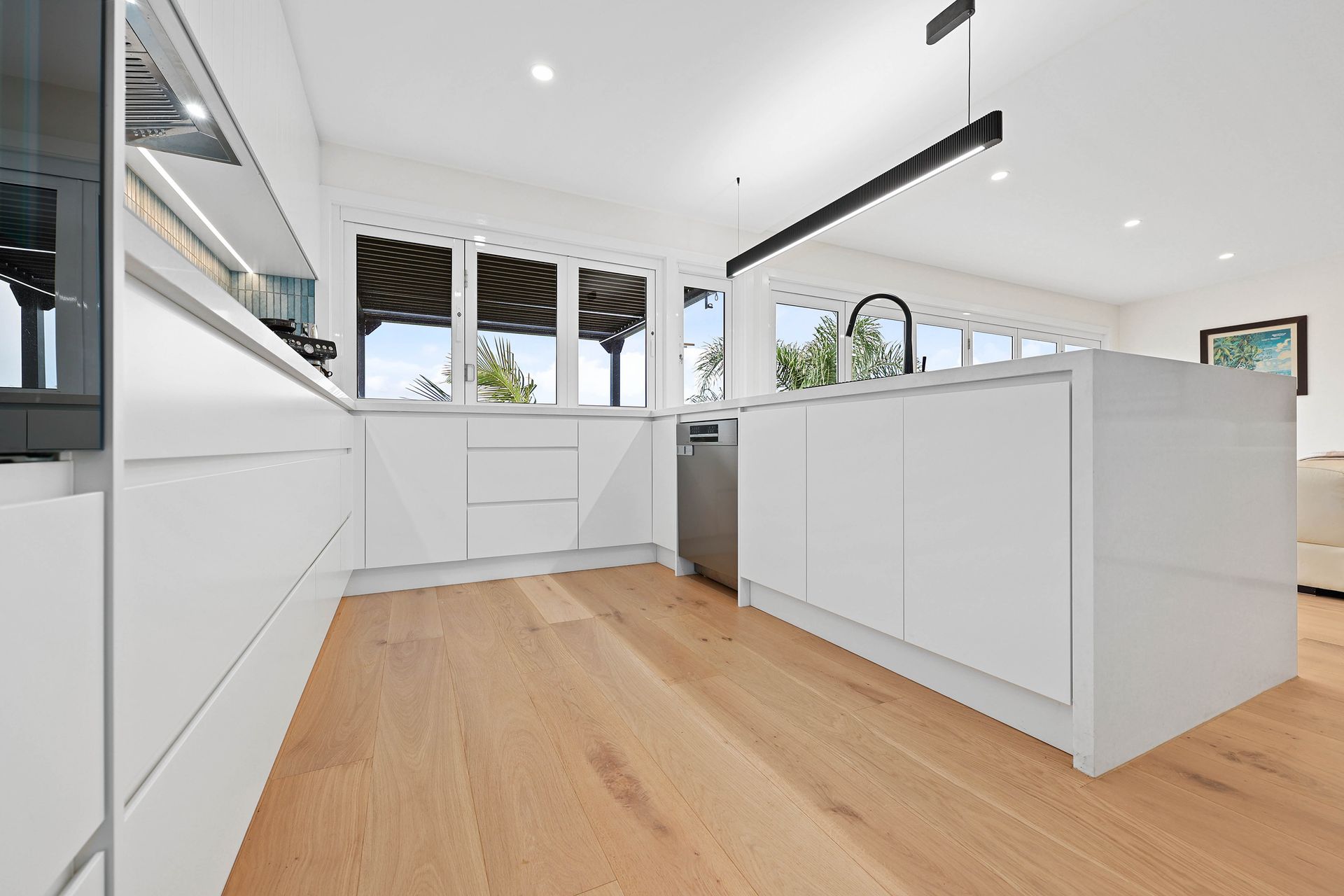 Bright Modern Kitchen with White Cabinets — Above & Beyond Interiors in Smeaton Grange, NSW