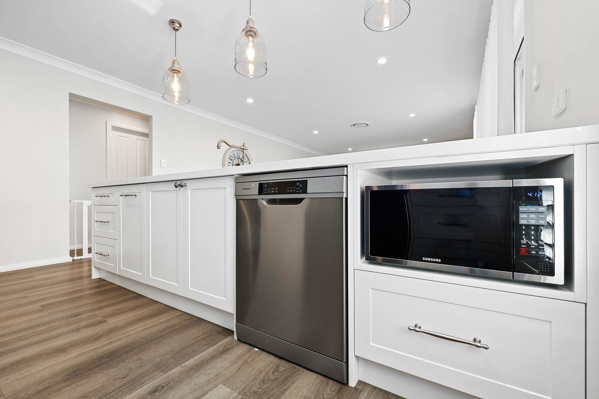 Bright White Modern Kitchen with Built-In Microwave, and Pendant Lights — Above & Beyond Interiors in Smeaton Grange, NSW