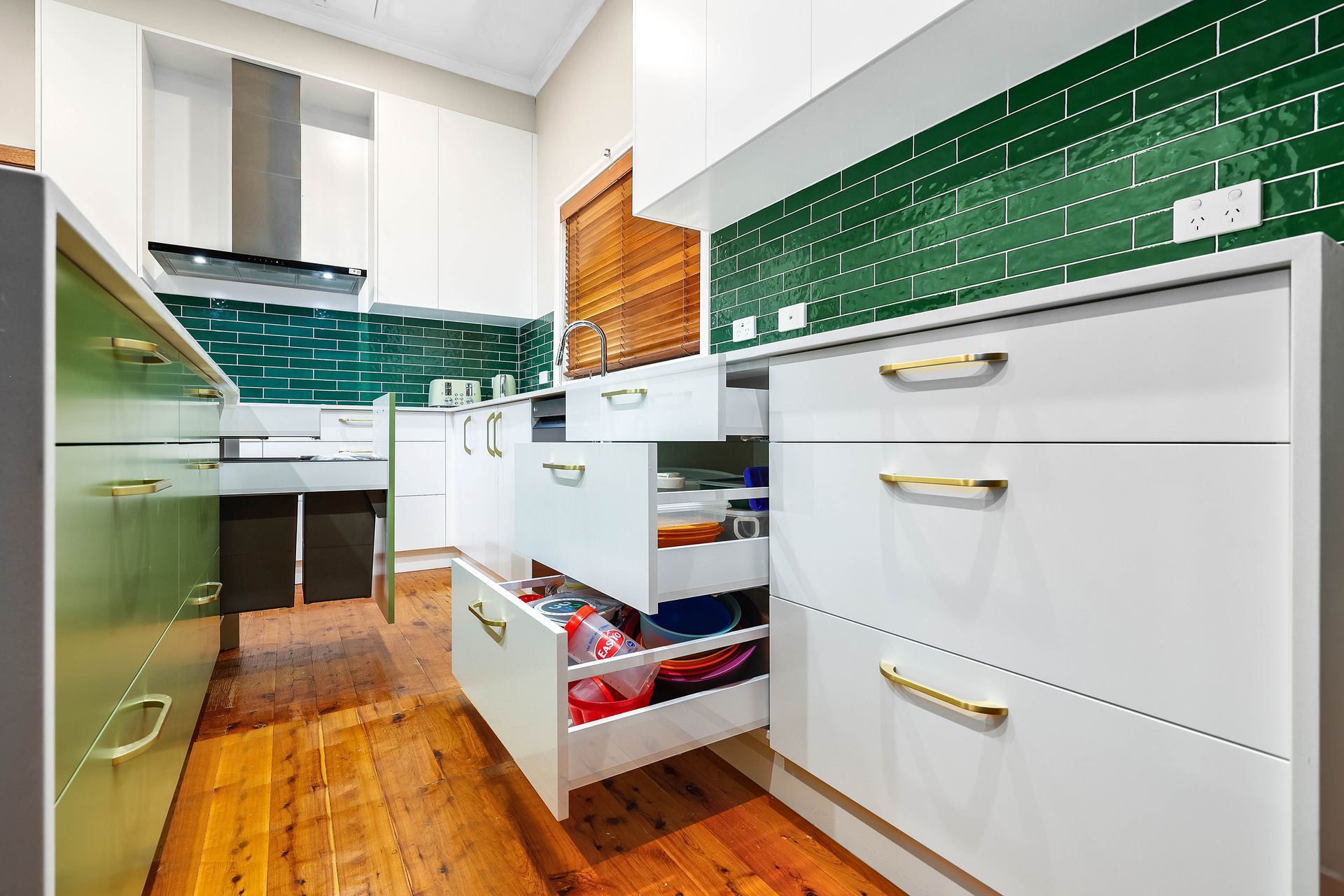Modern Kitchen with An Open Drawer on A Wooden Floor — Above & Beyond Interiors in Smeaton Grange, NSW
