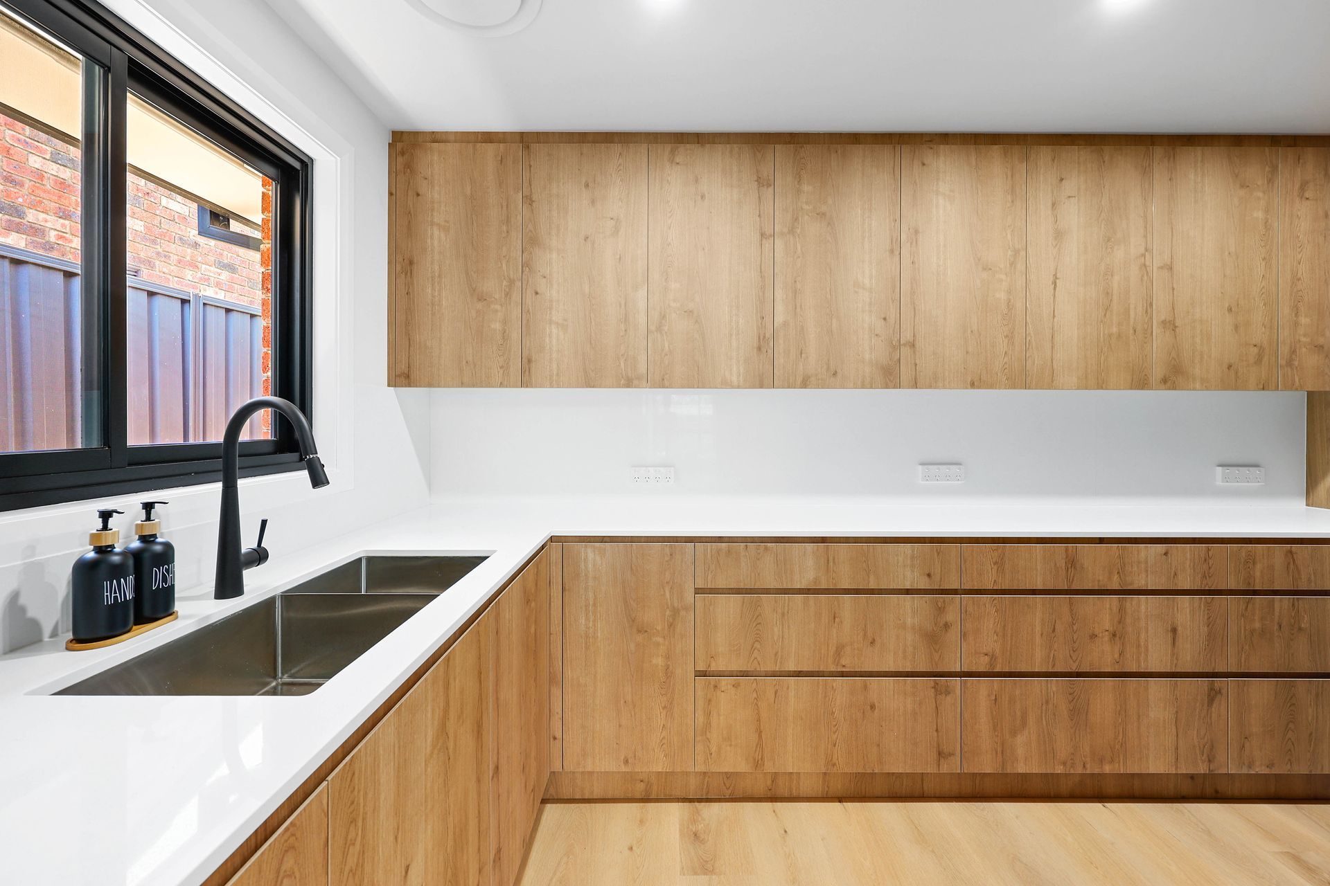 Modern Minimalist Kitchen with Wood Cabinets — Above & Beyond Interiors in Smeaton Grange, NSW