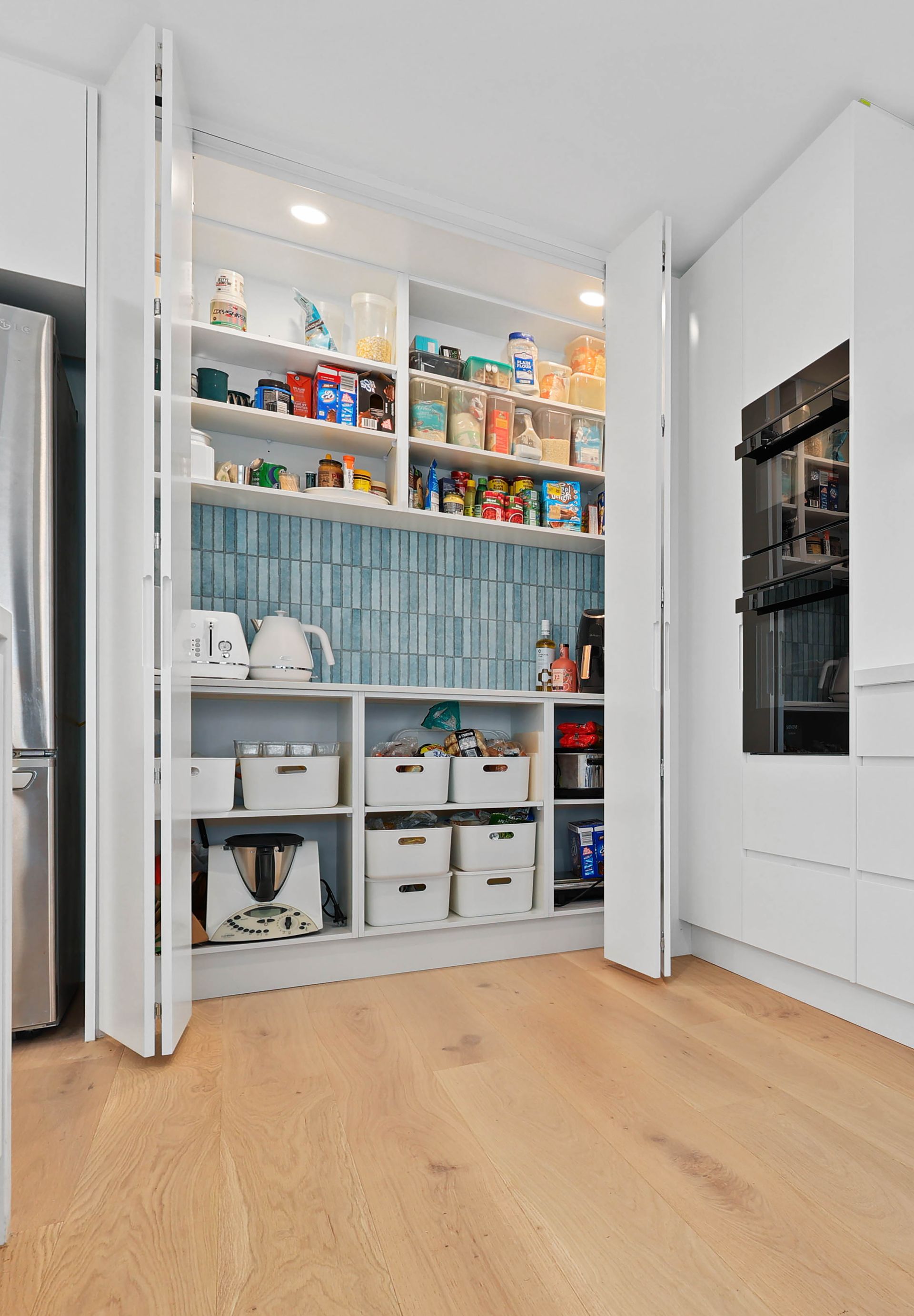Open Pantry Closet with Shelves of Kitchen Supplies — Above & Beyond Interiors in Smeaton Grange, NSW